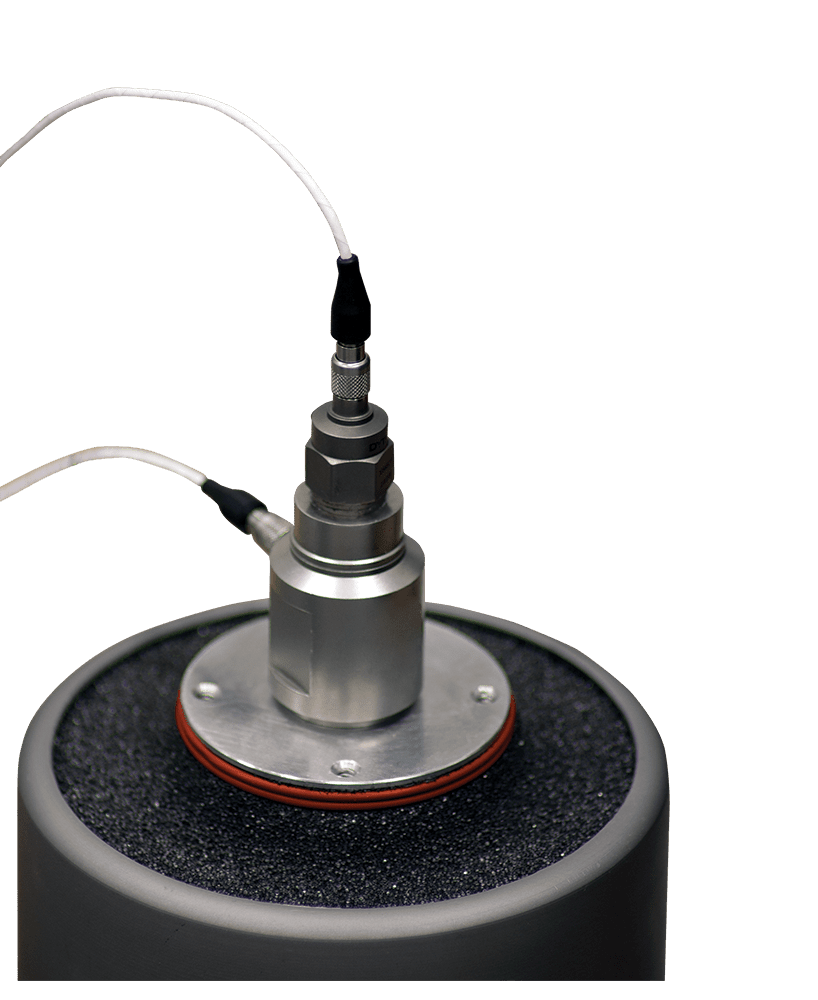 A close-up image of a back-to-back accelerometer setup on a shaker head.